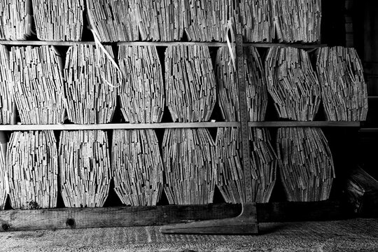 Traditional wooden shingles stored in an artisan workshop for heritage roofing