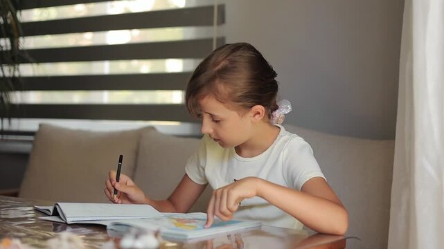 Child studying at home surrounded by books