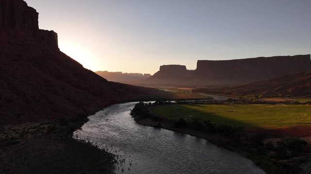 Drone flying straight forward over the Colorado river at sunrise in 4k