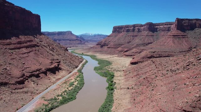 Drone flying high over the Colorado river with the camera tilting down slowly in 4k