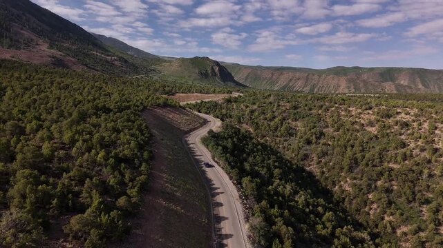 Drone following a car driving de La Sal mountain loop in Moab, USA in 4k