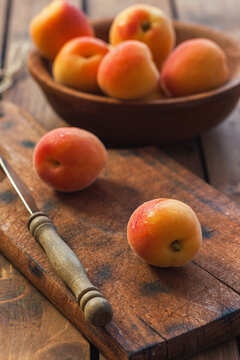 Fresh ripe apricots on the wooden background