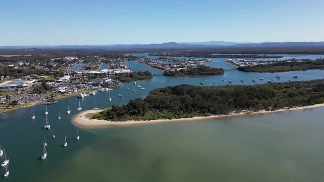 Aerial landscape of Port Macquarie with marina full of yachts and boats surrounded by coastal urban scenery and tourism attractions