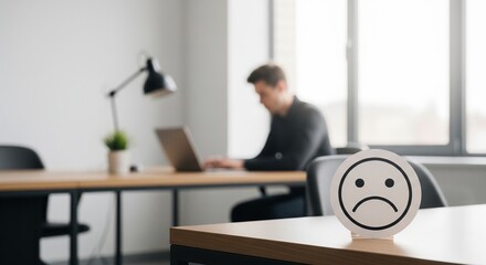 Fototapeta premium Stressed Person Working Late at Desk with Alarm Clock in Office Setting