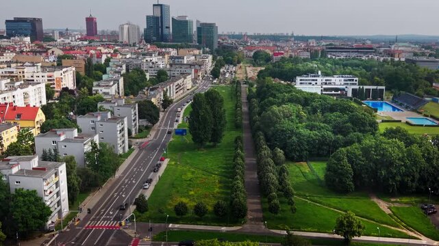 Aerial View Modern City District Green Park Residential Buildings Road Traffic Highrise Skyscrapers Horizon, drone perspective of a vibrant urban landscape 