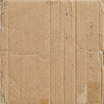 Brown cardboard paper texture background with creases and tears