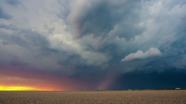 Colorful storm clouds at sunset moving across beautiful sky