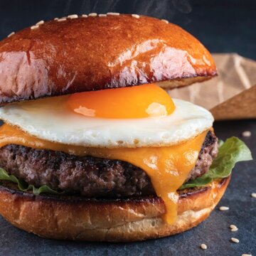 studio food photography of a stacked burger  image