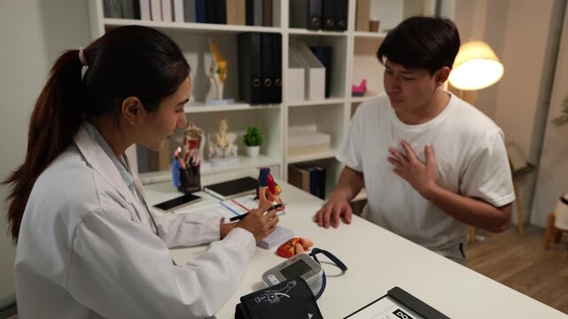 A doctor examines a patient, reviews injuries, and explains knee anatomy with a medical model during an orthopedic consultation in a modern clinic.