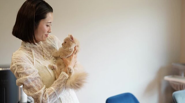 Woman embraces fluffy orange cat tenderly. Her eyes close as she gently holds the feline. Soft lighting highlights her quiet affection. Ideal for cozy, home, or pet care themes