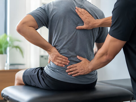 Physical Therapist Treating Man with Lower Back Pain