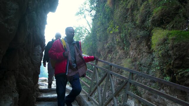 Person hiking on a narrow mountain trail in Chakrata, Dehradun, Uttarakhand