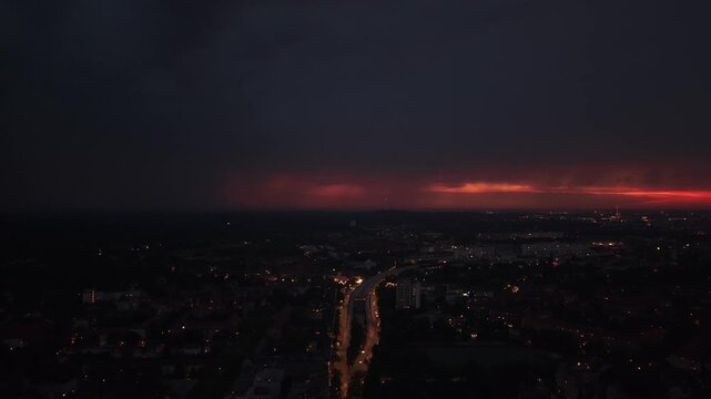City sunset, night lightning strike during summer thunderstorm. Magic aerial view drone