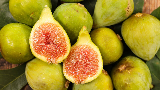 Fresh Green Figs Macro Background with Halved Ripe Fig Showing Texture