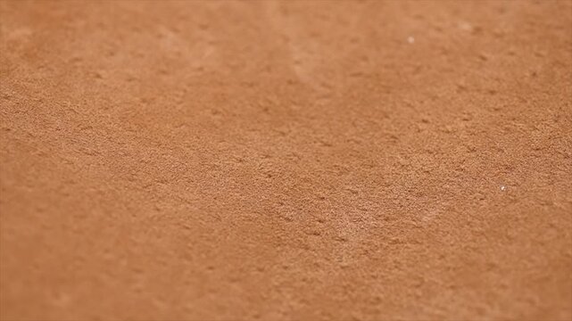 Brown suede texture background close up. Suede leather surface backdrop, genuine leather, top view. Suede of animal skin. Texture for design. Rotating background.