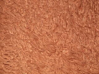 Full frame macro shot of light brown or copper-colored shaggy faux fur fabric texture, shiny synthetic fibers, perfect for fashion backgrounds, winter textile designs, and soft material backdrops © Eka