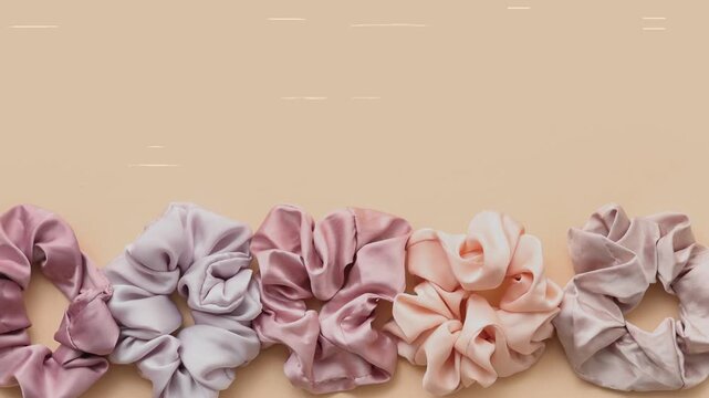 Trendy Silk Scrunchies animation. Trendy Silk Scrunchies Background. Set of Stylish Scrunchies on Color Background.