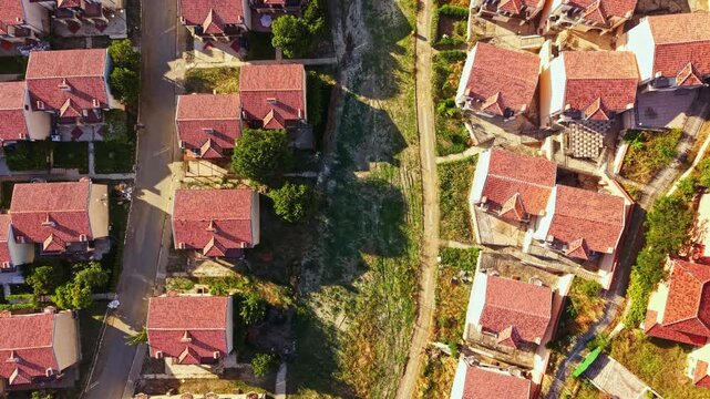 Elenite city shows the impact of a flood with damaged houses, changed landscape, and signs of water damage seen clearly from above. The area is showing evidence of recovery.