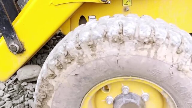 JCB Machine Leveling Gravel on Road Construction Site for Highway Infrastructure Development, Civil Engineering and Earthmoving Equipment Operations Progress