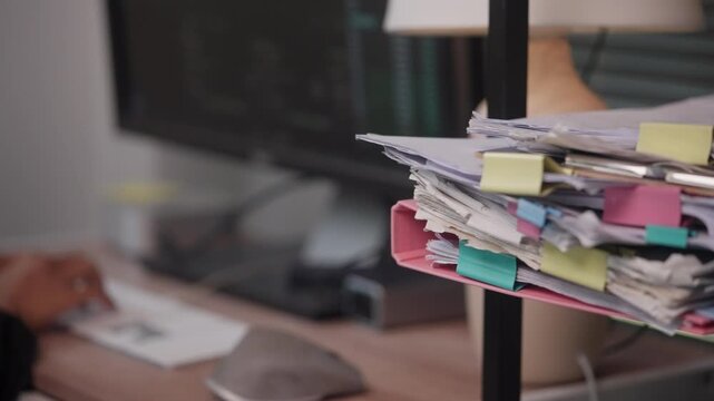 Stack of Business Documents on Office Desk During Daily Workflow