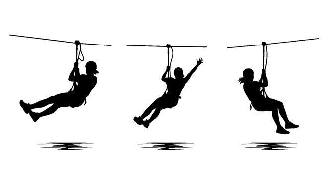 Silhouettes of people zip lining in action.