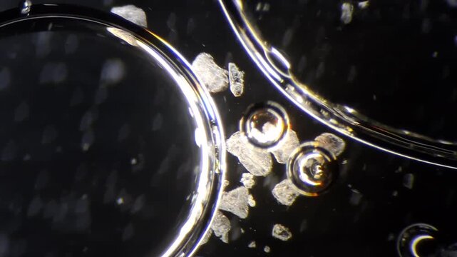 Chemical reaction between vinegar and baking soda under microscope, acid base substance interaction
