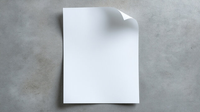 Blank Page on Textured Surface: A clean, white sheet of paper with a gently curled corner rests on a neutral, textured surface.