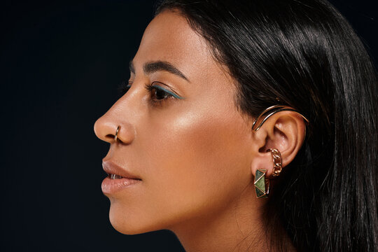 A stunning woman highlights the beauty of diverse skin and jewellery in a studio.