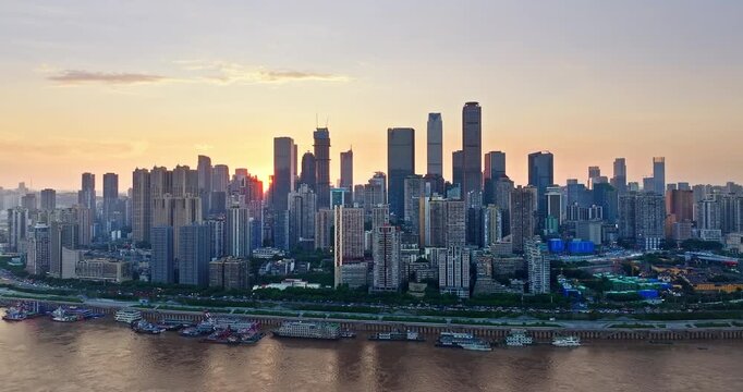 Aerial view of modern urban skyline during golden hour in Chongqing, China