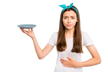Portrait of sad upset girl hold hand feel hungry have stomach ache want eat more unhealthy dieting...