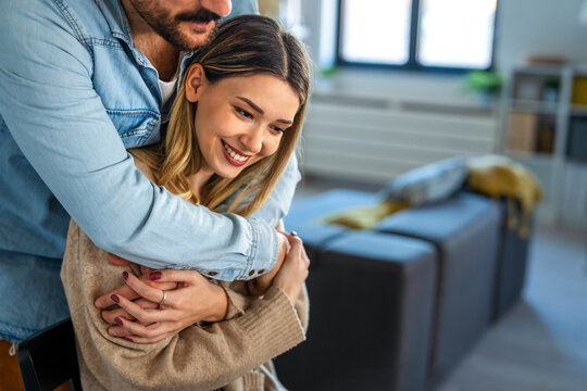 Happy couple in their new home, smiling and embracing as they start a new chapter together