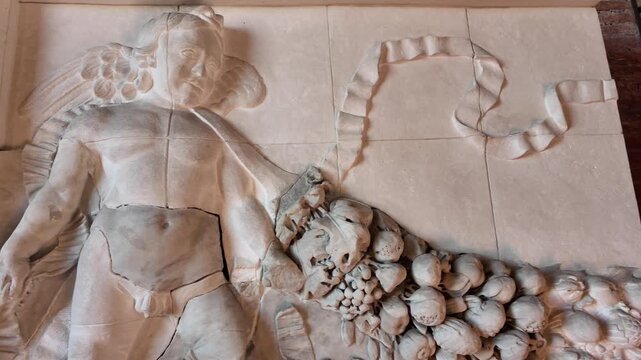 Ancient Roman marble bas-relief with putto and garland in Rome Italy