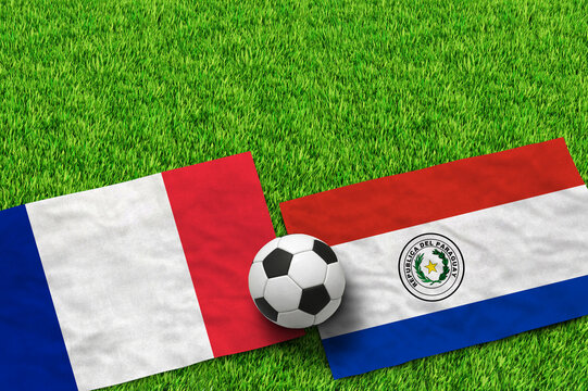 French and Paraguayan flags with soccer ball on green grass