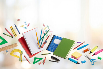 Fototapeta premium School supplies are spread out on a surface with bright colors and various tools for writing and drawing