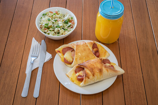 Brazilian enroladinho de salsicha Sausage Rolls Served with Salad and Juice