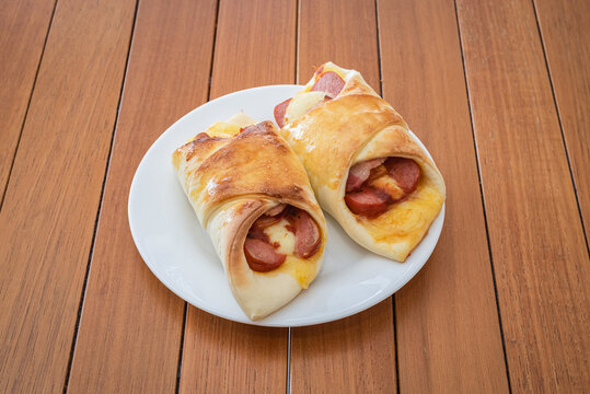 Two Brazilian enroladinho de salsicha - Sausage Rolls on Plate