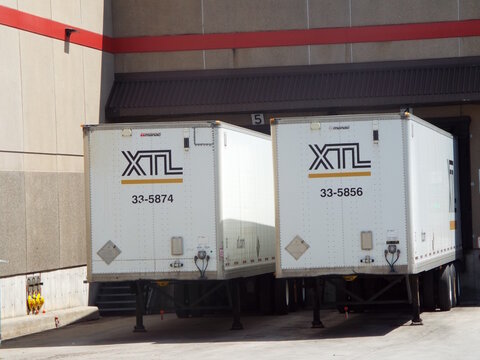 Gatineau,Quebec, Canada &ndash; May 21, 2026:Two "XTL transport trailers" (remorques) are docked at a warehouse loading bay for loading (chargement) or unloading on Bd Maloney O.