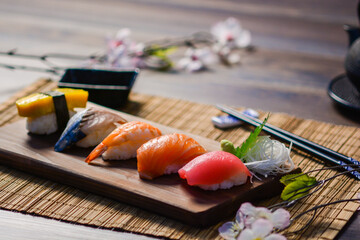 Mix sushi on wood dish, tuna, salmon, sea bass, sweet egg, shrimp sushi, Japanese food © William
