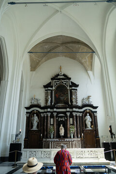 Ornate Church Altar and Visitor in Bruges Belgium