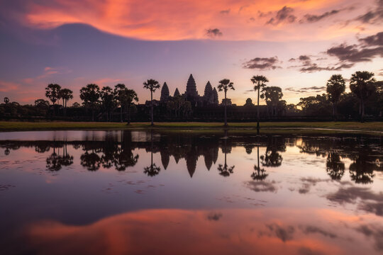 Illuminated dramatic clouds during sunrise above the silhouette of Angkor Wat Temple in Cambodia