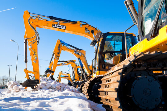 Riga, Latvia - February 8, 2026: New JCB crawler excavators on the street near the auto center with blue sky in the background