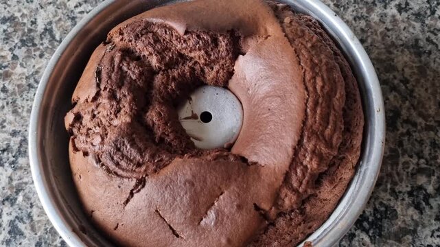 Top-Down Close-Up Zoom of Freshly Baked Chocolate Bundt Cake in Metal Baking Pan