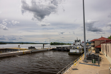 Fototapeta premium A barge with a load of oil passing through a lock and dam on the Mississippi River.