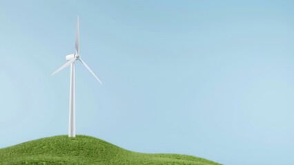 Fototapeta premium Wind turbine on a green hill with blue sky background