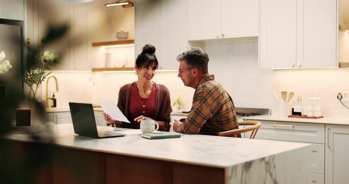 Couple, discussion and paperwork in home with laptop, financial planning and review mortgage loan. Married, mature people and talk in kitchen with documents, debt financing and check credit score.