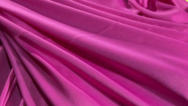 Pink fabric draped with shadows