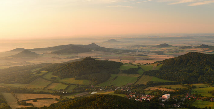 Aerial Golden Hour Panorama of a Bohemian Village with a Grand Palace Nestled Among Rolling Hills