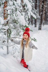Fototapeta premium A girl laughs in the forest in winter
