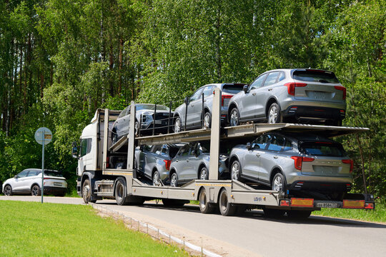 Minsk, Belarus. May 15, 2026. Double decker open trailer truck fully loaded with modern silver crossover SUVs Haval Jolion being transported for dealership delivery on the highway. New Haval fleet