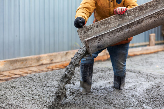 Closeup shot of concrete casting on reinforcing metal bars of floor in industrial construction site